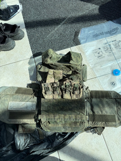 Captured Russian 6B45 body armour laid open, showing its EMR camouflage carrier, attached pouches and protective sections.