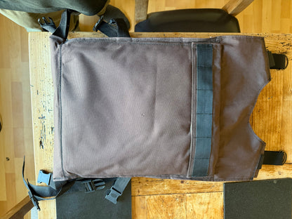 Rear view of the improvised brown Ukrainian body-armour carrier, showing its plain back panel, shoulder straps and adjustable side buckles.