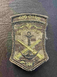 Military patch with anchor and crossed rifles design on a dark background