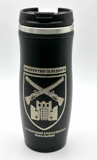 Black travel mug with a military emblem and text on a white background