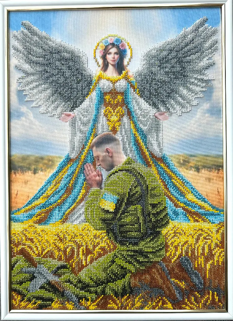 Cross-stitched angel over a praying soldier in a field with a blue sky.