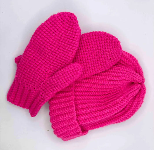 A set of bright pink handmade knit gloves and a matching hat.