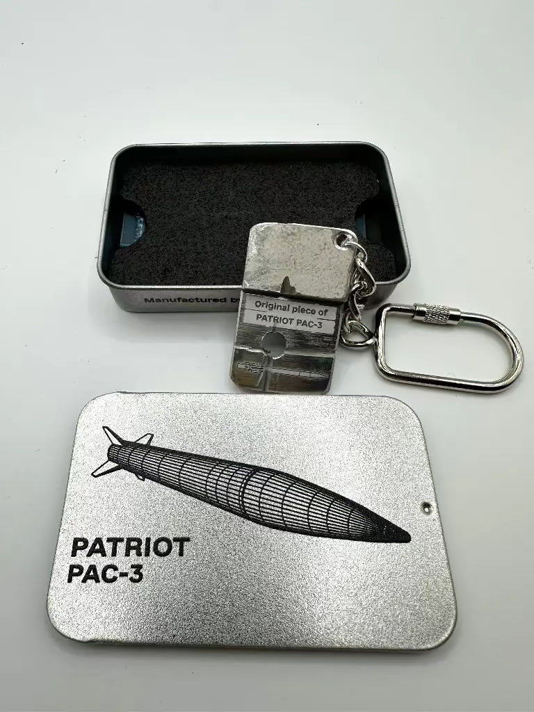 Metal keychain and card with 'Patriot PAC-3' design on a gray background