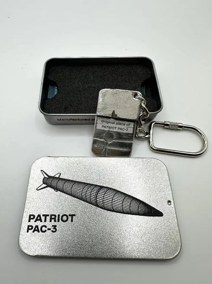 Metal keychain and card with 'Patriot PAC-3' design on a gray background