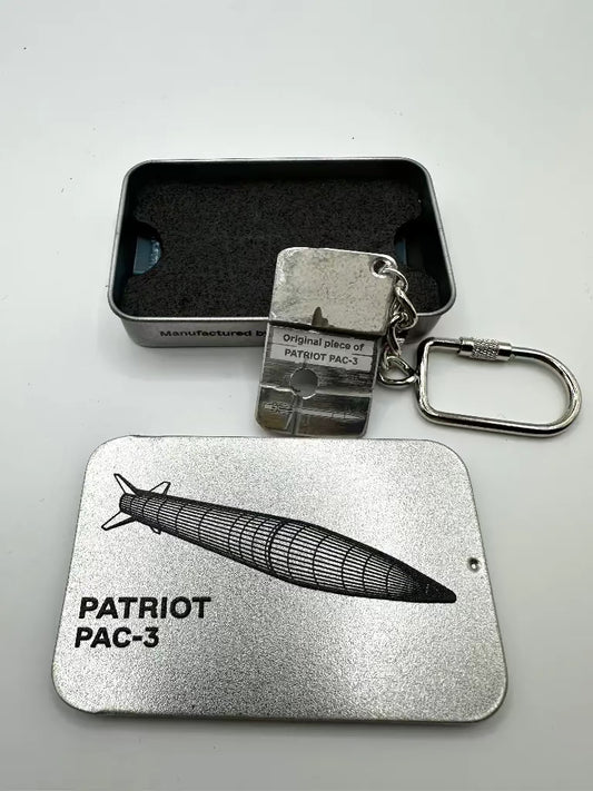 Metal keychain and card with 'Patriot PAC-3' design on a gray background
