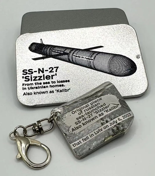Metal keychain with 'SS-N-27 Sizzler' design and text on a gray background