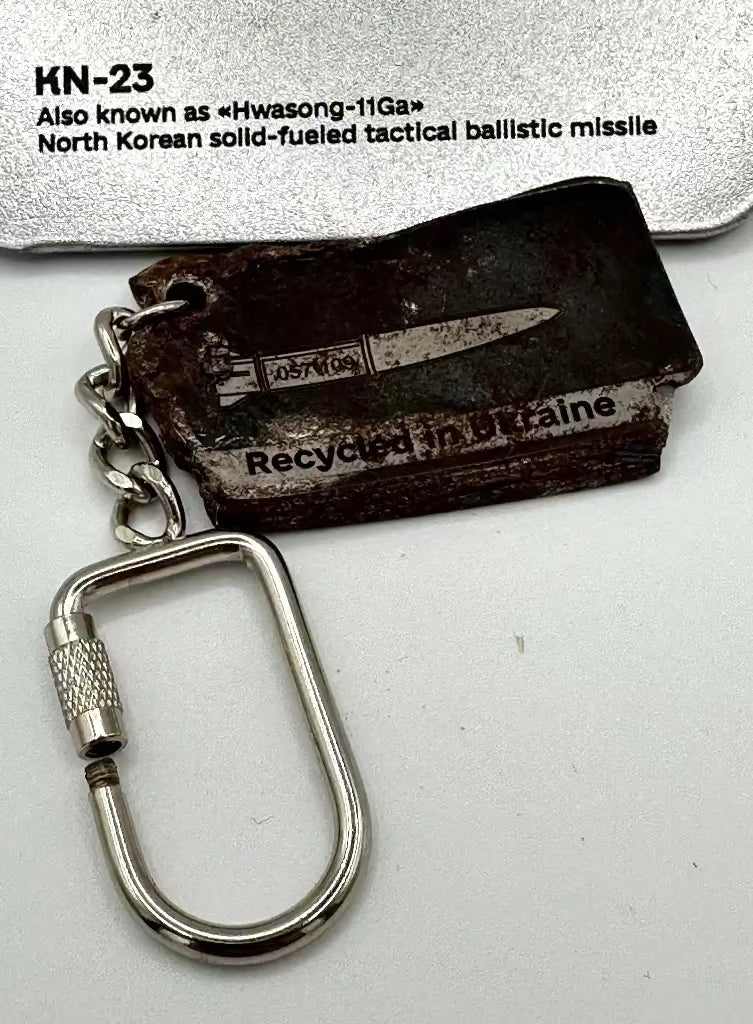 Keychain with a small knife and text 'Recycled in Ukraine' on a white background