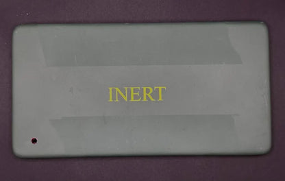 Rectangular gray object with 'INERT' text on a purple background