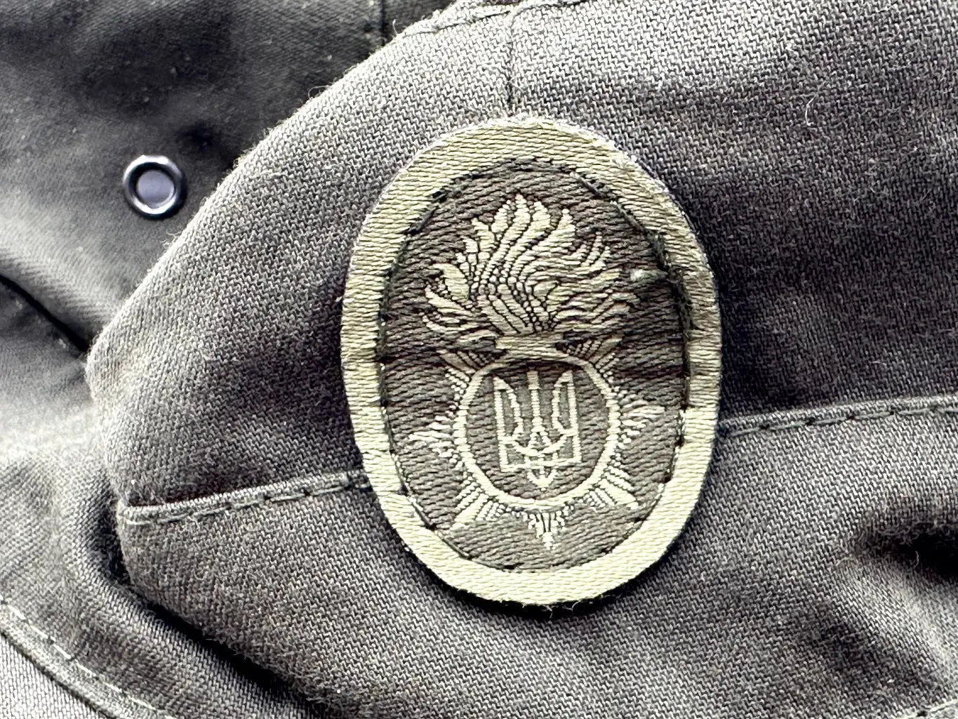 Close-up of a military uniform patch with an emblem on a textured fabric background