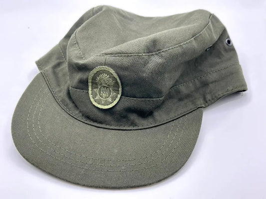 Green military-style cap with a badge on a white background
