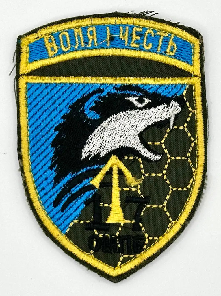 Emblem with a wolf's head, blue background, and text on a white background