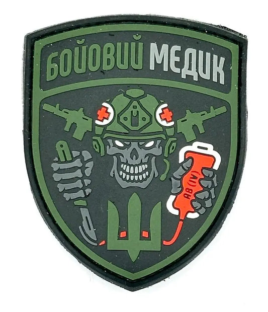 A morale patch featuring a graphic with a skull, guns, and tactical gear, with the text 'Frontline medic' and various decorative elements in green, black, and orange colors.