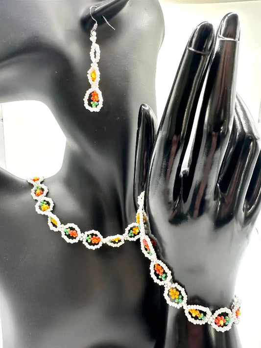 Necklace and earrings with colorful beads on a mannequin and hand model.