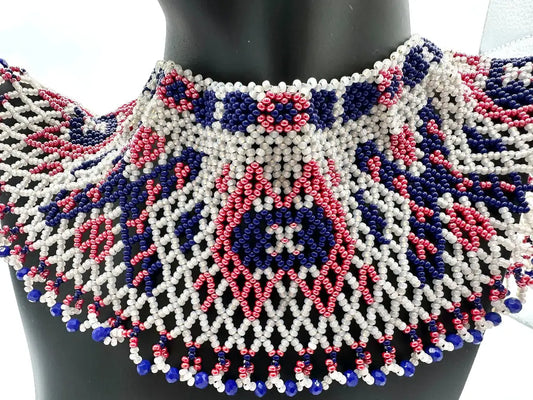 Beaded necklace with white, pink, and blue pattern on a mannequin