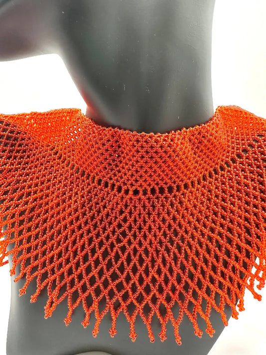 Orange knitted collar on a mannequin against a white background